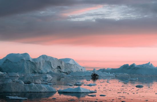 Fine art photographer Michael Schauer captures Icebergs on the coast of Greenland gently being lit by an arctic sunset creating a colour similar to Panone's living coral colour of the year 2019