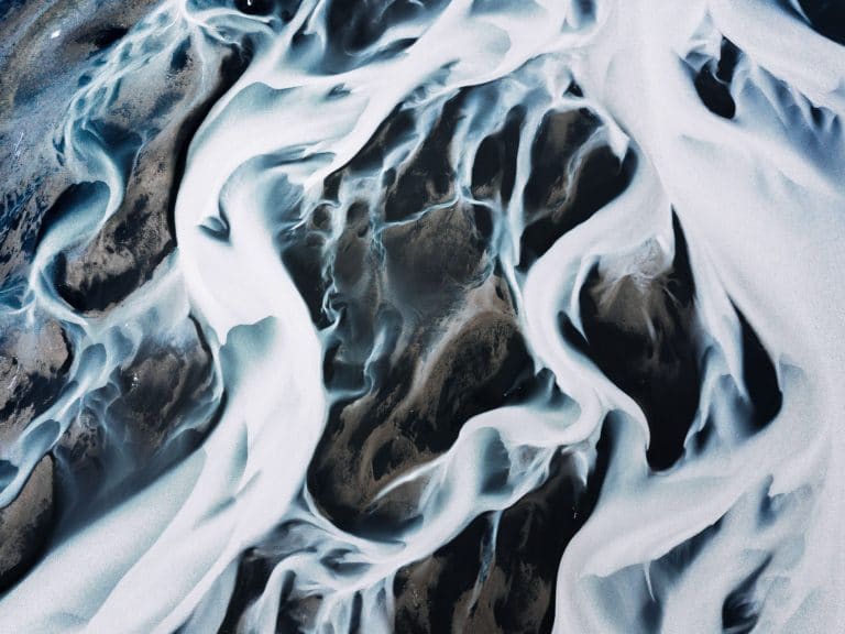 Abstract shapes and forms of water, rivers, glaciers and mountains in the moody Icelandic landscape captured by fine art photographer Michael Schauer