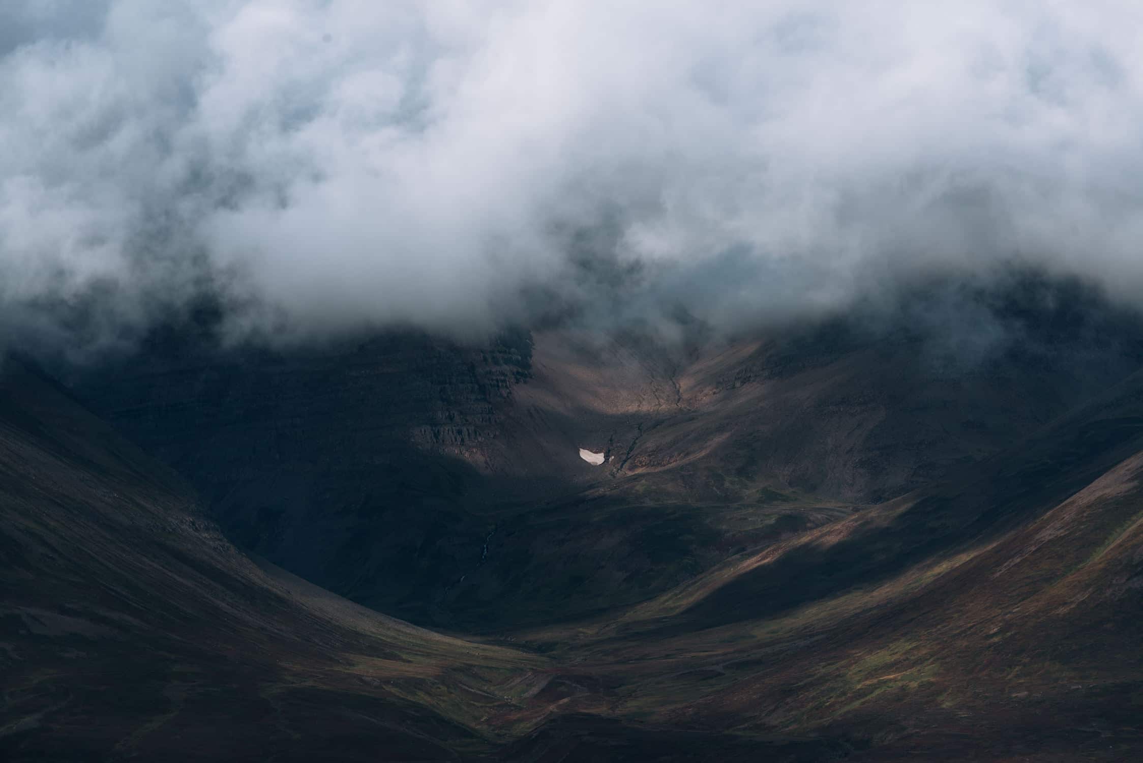 Abstract shapes and forms of water, rivers, glaciers and mountains in the moody Icelandic landscape captured by fine art photographer Michael Schauer