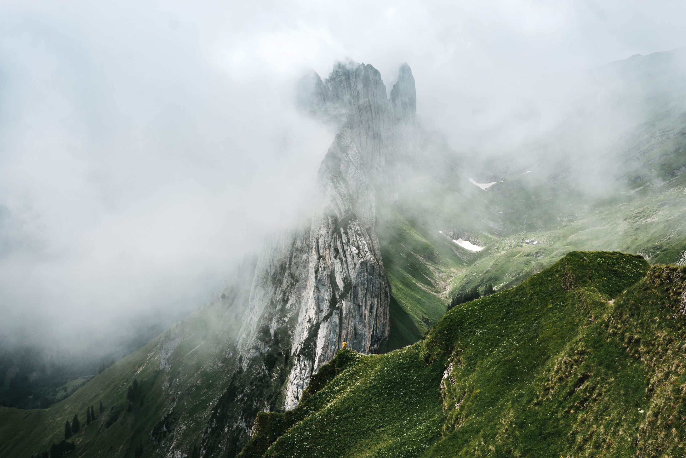Minimalist view over the Saxer Luecke in Appenzell, Switzerland as the thick fog covered the majestic mountains and left us with a moody and minimalist landscape by Michael Schauer
