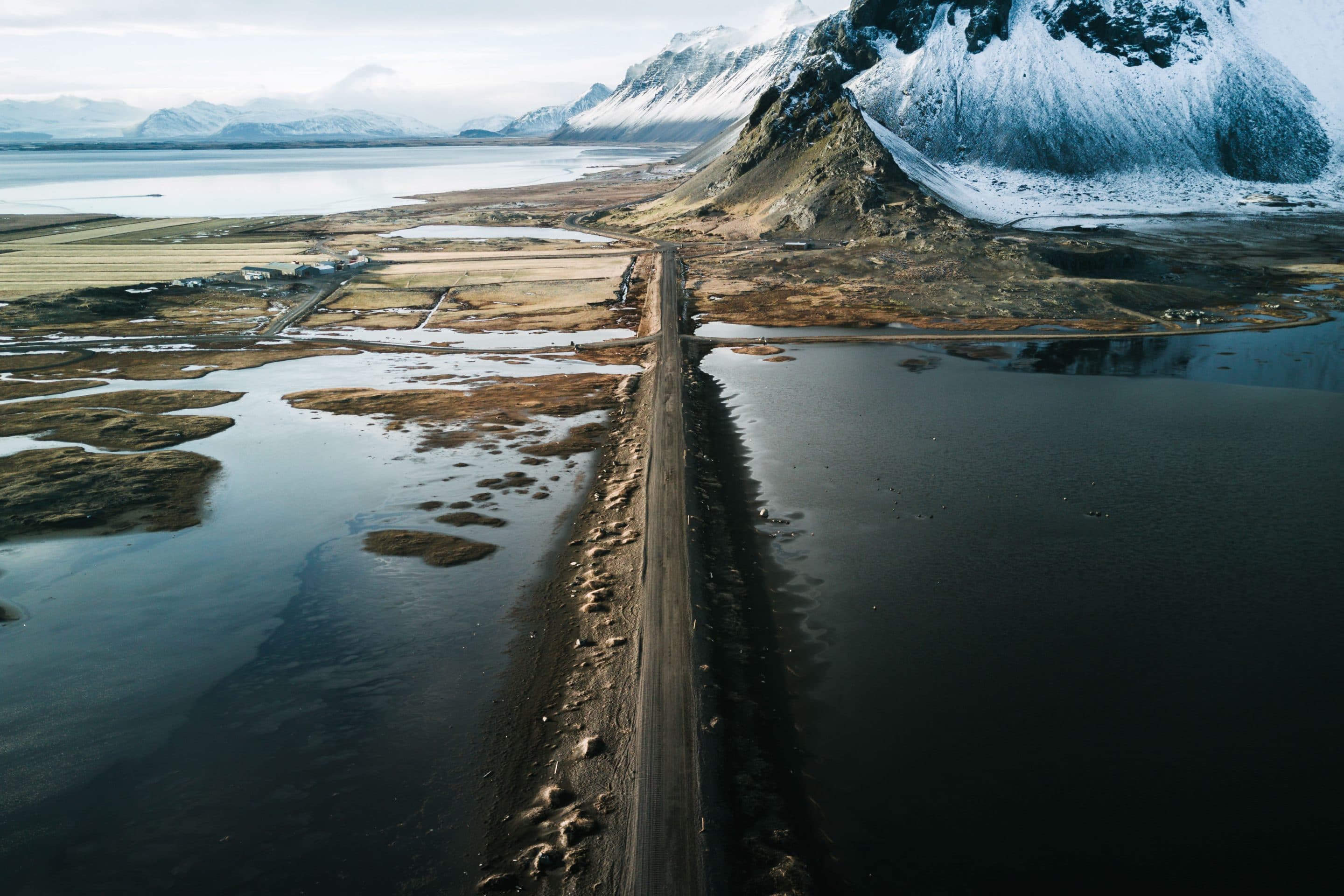 The Stokksnes peninsula in Iceland during a sunset dipping the mountain and beach landscape in moody light by photographer Michael Schauer