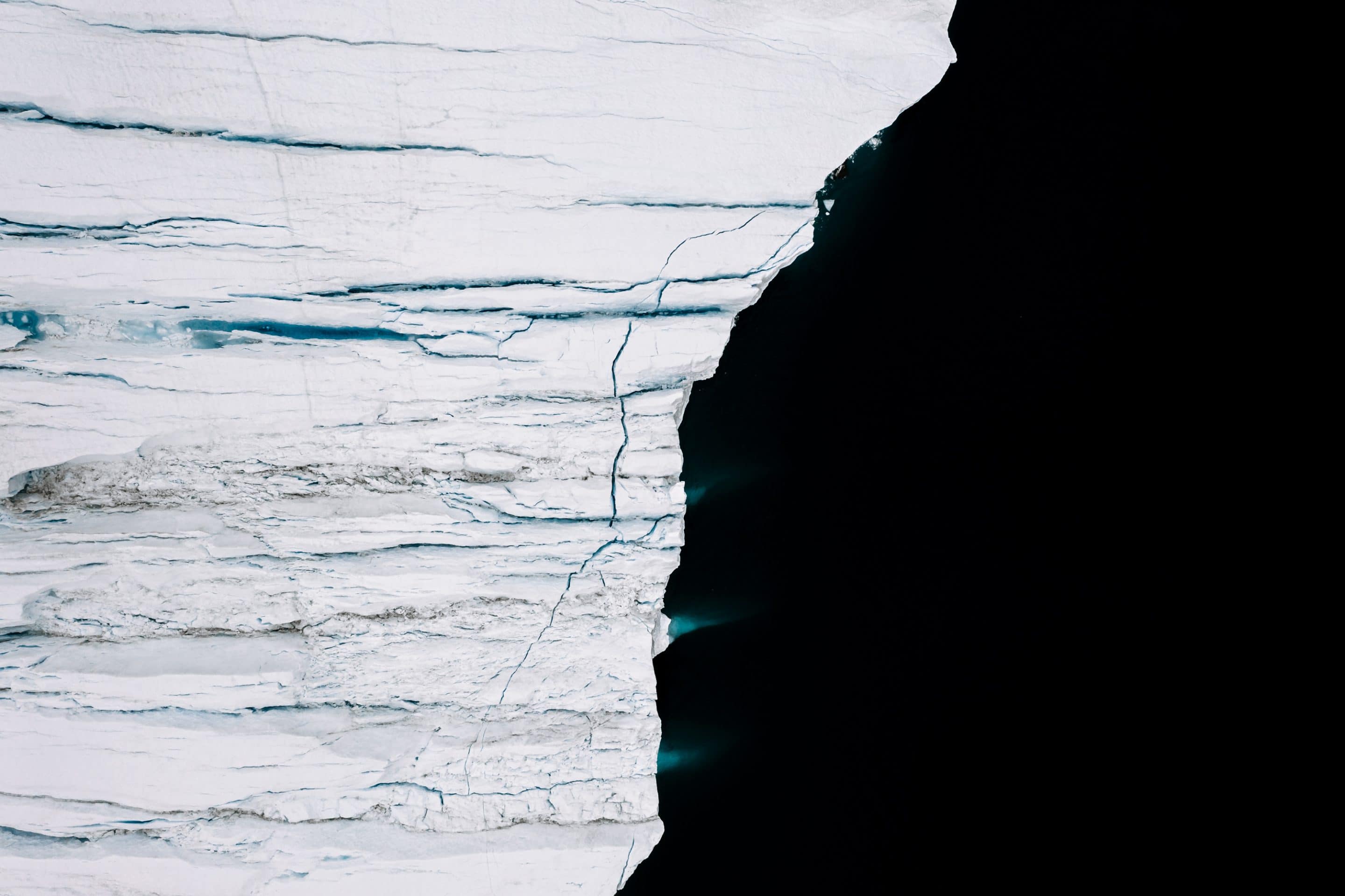 The endlessly complex landscape of abstract shapes and forms of icebergs in the Atlantic ocean at the west Greenland coast by Fine Art photographer Michael Schauer